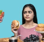 a woman eating a bowl of fruit