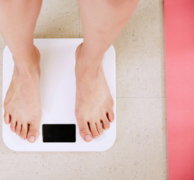 person standing on white digital bathroom scale